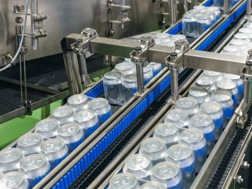 packed soft drink can on conveyor belt