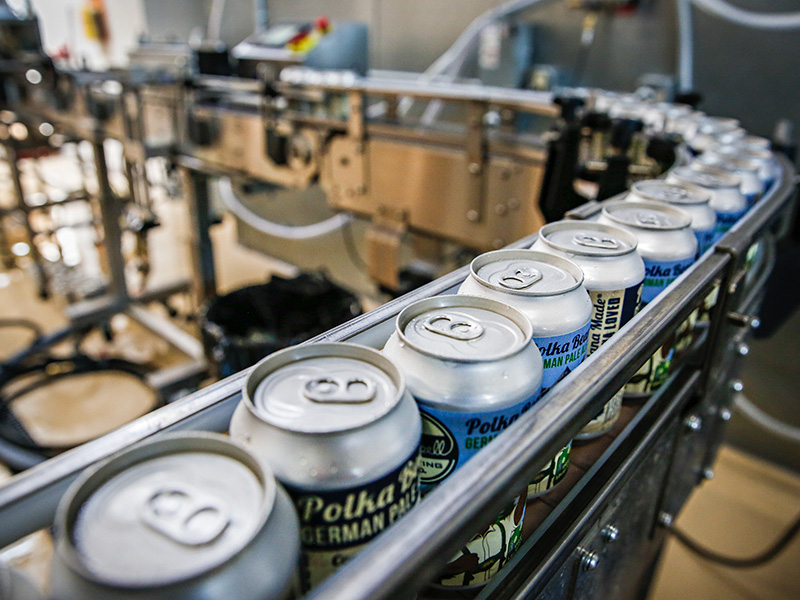 filled can on conveyor belt