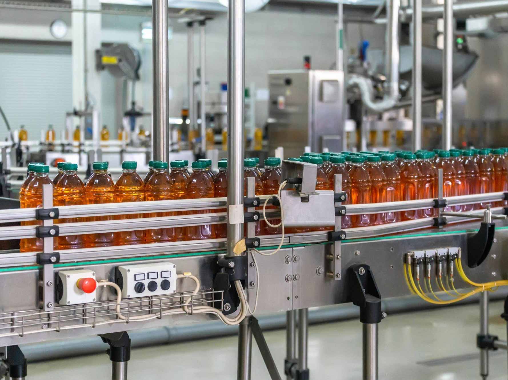 filled PET bottle on conveyor belt