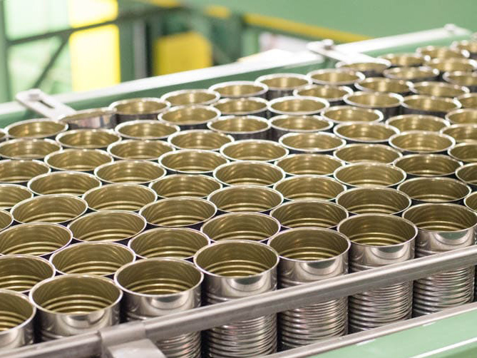 empty tin can on conveyor belt