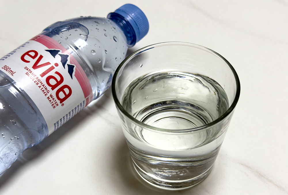 a glass of water and a bottle of water