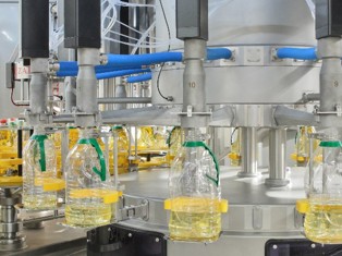 Close view of filling heads on equipment pictured by MIC