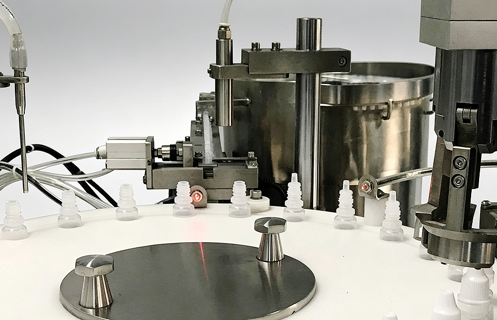 Rotary vial filling mechanis