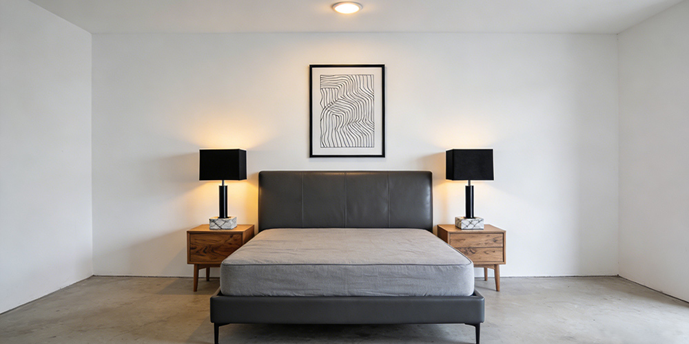 two bedside tables by the bed